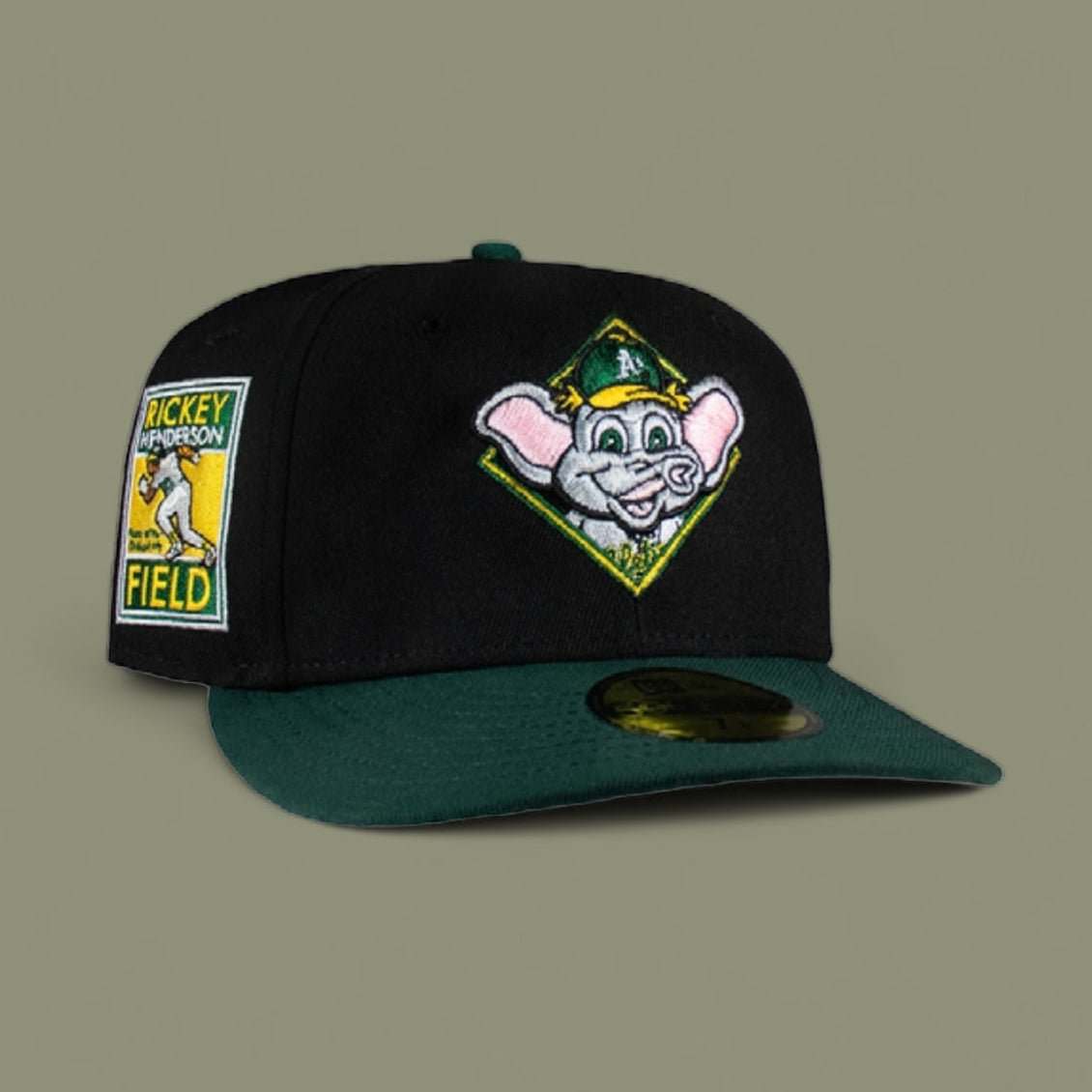 A black and green fitted baseball cap with a cartoon character logo on the front.