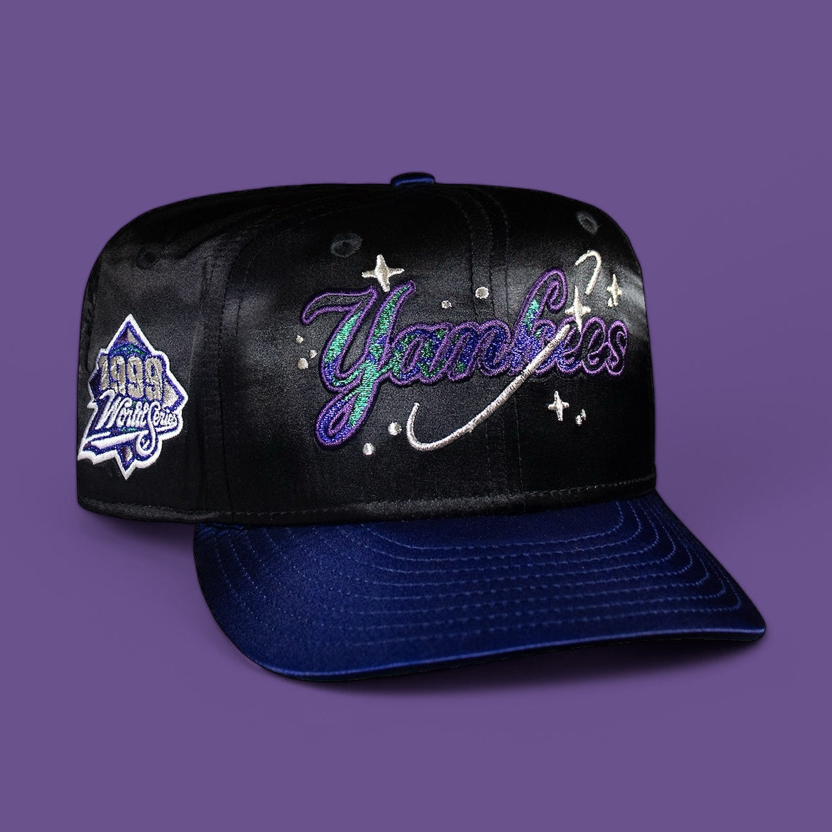 A black and blue New York Yankees baseball cap with satin finish and embroidered script.